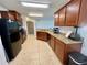 Kitchen with granite countertops, black appliances, and warm wood cabinetry at 6698 Wirevine Dr, Brooksville, FL 34602
