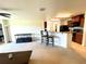 A spacious living room featuring carpet flooring and an open layout to the kitchen area at 6698 Wirevine Dr, Brooksville, FL 34602