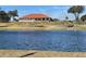 A beautiful water view featuring a community building with a red roof at 6698 Wirevine Dr, Brooksville, FL 34602
