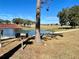 Scenic water feature with a grill surrounded by a lush green lawn, and mature trees at 6698 Wirevine Dr, Brooksville, FL 34602