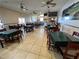 Wide angle shot of the 19th Hole Bar & Lounge restaurant featuring ceiling fans and many tables at 6698 Wirevine Dr, Brooksville, FL 34602