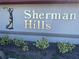 Attractive community sign reading Sherman Hills with a golf silhouette and lush landscaping at 6698 Wirevine Dr, Brooksville, FL 34602