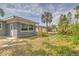 Backyard of home with an adjacent home and tropical landscaping at 5330 Dr Martin Luther King Jr St S, St Petersburg, FL 33705