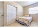 Cozy bedroom with white doors and tile floors at 5330 Dr Martin Luther King Jr St S, St Petersburg, FL 33705