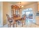 Elegant dining area features wooden furniture set, detailed china cabinet, chandelier, and easy access to living area at 5330 Dr Martin Luther King Jr St S, St Petersburg, FL 33705