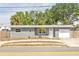 Charming single-story home with a well-maintained lawn, garage, and inviting front entrance, with shade trees overhead at 5330 Dr Martin Luther King Jr St S, St Petersburg, FL 33705