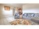 Cozy living area with tile flooring, decorative rug, and furniture set, leading to a dining space in the background at 5330 Dr Martin Luther King Jr St S, St Petersburg, FL 33705