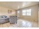 Bright living room showcasing tile floors, a comfortable sofa, chair, and ample natural light from the large window at 5330 Dr Martin Luther King Jr St S, St Petersburg, FL 33705
