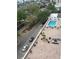 Scenic aerial view of a community pool area with lounge seating and lush landscaping at 33 S Gulfstream Ave # 803, Sarasota, FL 34236