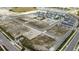 Aerial view of the community featuring empty home lots with the community bordering a lake and recently constructed houses at 200 Eagleston Ln, Lakewood Ranch, FL 34240