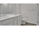 Modern bathroom with glass enclosed shower, double sink vanity, and neutral tile floor at 200 Eagleston Ln, Lakewood Ranch, FL 34240
