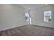 Bright bedroom with neutral carpet, two windows offering ample natural light, and clean white walls at 200 Eagleston Ln, Lakewood Ranch, FL 34240