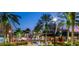 Picturesque town center with palm trees, fountains, and inviting storefronts at twilight at 208 Eagleston Ln, Lakewood Ranch, FL 34240