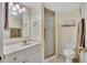 Functional bathroom with a shower, white vanity, and neutral finishes at 12300 Vonn Rd # 1102, Largo, FL 33774