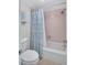 Bathroom features a shower-tub combination with a stylish blue shower curtain and coordinated tile at 12300 Vonn Rd # 1102, Largo, FL 33774