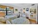 Inviting bedroom with two twin beds, sunny window, and access to an open kitchen, creating a cozy retreat at 12300 Vonn Rd # 1102, Largo, FL 33774