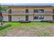 Exterior of a condo building with lush landscaping and a well-maintained lawn, enhancing its visual appeal at 12300 Vonn Rd # 1102, Largo, FL 33774