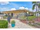 Inviting clubhouse entrance with a brick walkway, manicured landscaping, and well-maintained facade at 12300 Vonn Rd # 1102, Largo, FL 33774