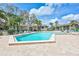 Resort style pool area with seating and sun umbrellas, surrounded by lush landscaping and condominium buildings at 12300 Vonn Rd # 1102, Largo, FL 33774