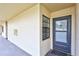 Condo unit entrance with a covered walkway, a small window, and a black door with the number 1102 at 12300 Vonn Rd # 1102, Largo, FL 33774