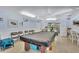 A game room with a pool table and card tables offers an excellent space for entertainment and relaxation at 12300 Vonn Rd # 1102, Largo, FL 33774