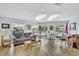 Bright living room featuring comfortable seating, a view of the pool, and an abundance of natural light at 12300 Vonn Rd # 1102, Largo, FL 33774