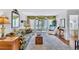 Bright living room featuring neutral walls, plush carpet, and access to a screened lanai at 12300 Vonn Rd # 1102, Largo, FL 33774