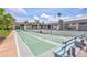 Community shuffleboard and tennis courts with blue benches and green play surfaces, providing recreational activities at 12300 Vonn Rd # 1102, Largo, FL 33774