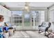 Enclosed lanai with sun shades and a ceiling fan, offering a bright additional space to relax at 12300 Vonn Rd # 1102, Largo, FL 33774