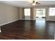 Bright living room with hardwood floors, neutral walls, and sliding doors to screened porch at 15120 Brushwood Dr, Tampa, FL 33624