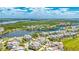 Expansive aerial view of a vibrant waterfront community with lush landscaping and serene water features at 283 Saint Lucia Dr # 101, Bradenton, FL 34209