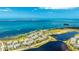 Panoramic aerial shot showcases the coastal community near the blue ocean and a lake at 283 Saint Lucia Dr # 101, Bradenton, FL 34209