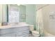 Well-lit bathroom featuring a vanity with a modern sink, a toilet, and a shower with a curtain at 283 Saint Lucia Dr # 101, Bradenton, FL 34209