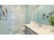 Bright bathroom with a glass-enclosed shower, marble tile, modern vanity, and coastal accents at 283 Saint Lucia Dr # 101, Bradenton, FL 34209