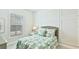 Cozy bedroom with a large window and tropical-themed bedding at 283 Saint Lucia Dr # 101, Bradenton, FL 34209