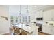 Bright, modern kitchen with white cabinets, stainless steel appliances, and a large island at 283 Saint Lucia Dr # 101, Bradenton, FL 34209