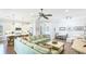 Open concept living area flows into kitchen and dining area with large comfortable sectional sofa at 283 Saint Lucia Dr # 101, Bradenton, FL 34209