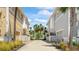 Charming street view showcasing the coastal architecture, palm trees, and inviting landscaping of the neighborhood at 283 Saint Lucia Dr # 101, Bradenton, FL 34209