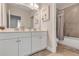 Bathroom featuring double vanity with modern fixtures, mirror, and tiled shower-tub combo at 7575 Sea Oak Ct, Parrish, FL 34219