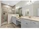Well-lit bathroom with double vanity, tiled shower, and modern fixtures at 7575 Sea Oak Ct, Parrish, FL 34219