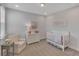 Cozy Bedroom with white crib, comfortable chair, dresser, and charming 'twinkle twinkle little star' decor at 7575 Sea Oak Ct, Parrish, FL 34219