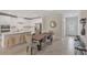 Open-concept dining area featuring a wooden table with seating for six, connecting to the kitchen at 7575 Sea Oak Ct, Parrish, FL 34219