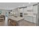 Stylish kitchen with white cabinets, stainless steel appliances, and island seating at 7575 Sea Oak Ct, Parrish, FL 34219