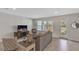 Bright living room featuring neutral colors, large windows, and comfortable seating at 7575 Sea Oak Ct, Parrish, FL 34219