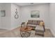 Living room featuring a gray sectional sofa, coffee table, and stylish decorative wall art at 7575 Sea Oak Ct, Parrish, FL 34219