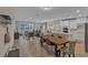 Open-concept living area with tile floors, seamlessly connecting to dining and kitchen at 7575 Sea Oak Ct, Parrish, FL 34219
