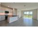 Open-concept kitchen with an island, stainless steel appliances, and lots of natural light at 9270 Gulf Haven Dr, Parrish, FL 34219
