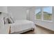 Cozy bedroom featuring natural light, light hardwood floors and a neutral color scheme at 9608 Brave Buck Ave, Land O Lakes, FL 34638