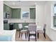 Eat in kitchen with olive green cabinets, stainless steel appliances, and stylish tile backsplash at 9608 Brave Buck Ave, Land O Lakes, FL 34638