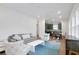 Bright living room with contemporary furnishings and view into kitchen at 9608 Brave Buck Ave, Land O Lakes, FL 34638